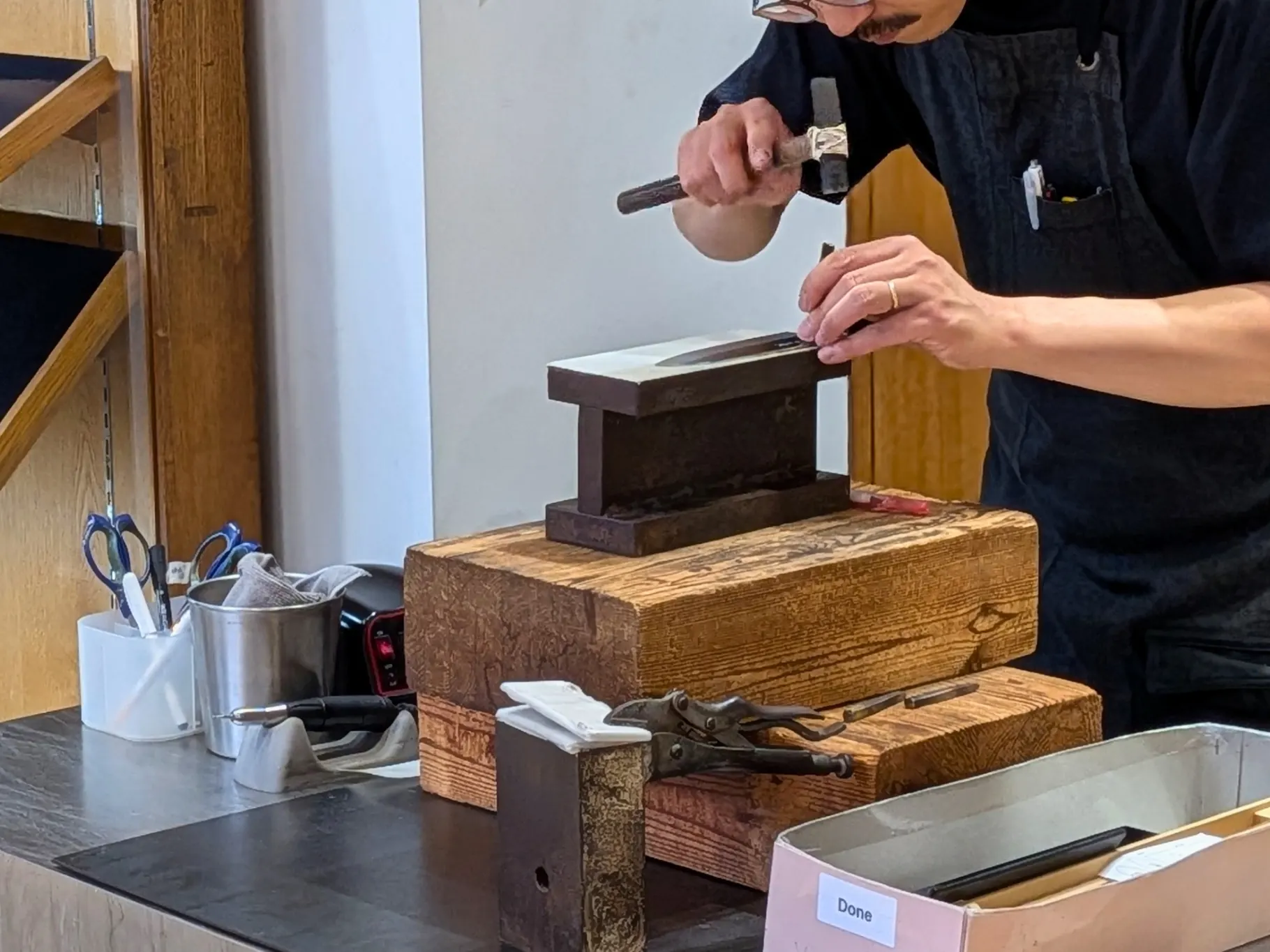 A craftsman hand-engraving a name on a Japanese knife