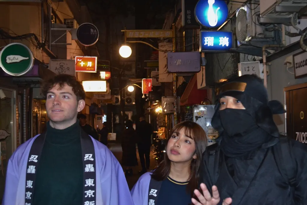 Guests laughing with the Ninja guide in a back alley