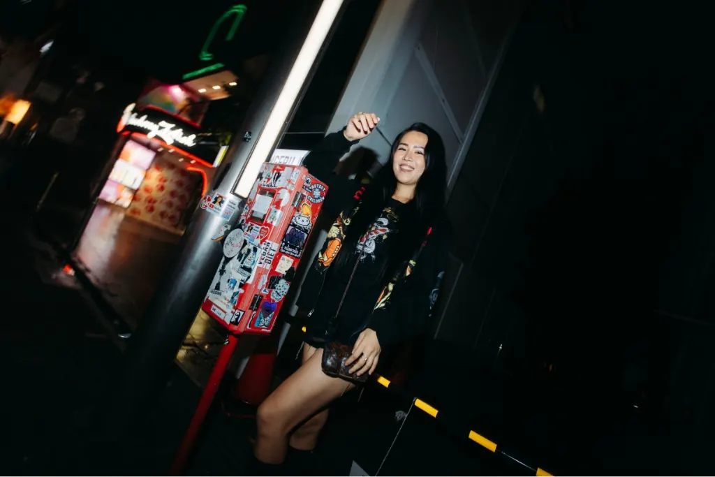 Guests posing on a neon street at night