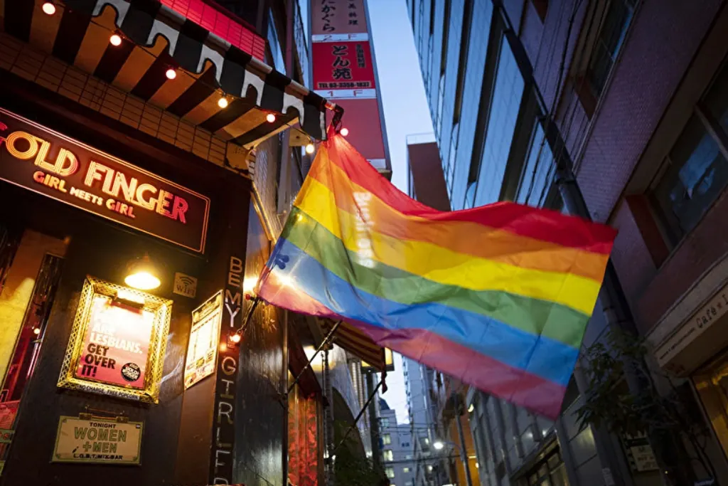 A rainbow flag outside a bar in Shinjuku Nichome at dusk