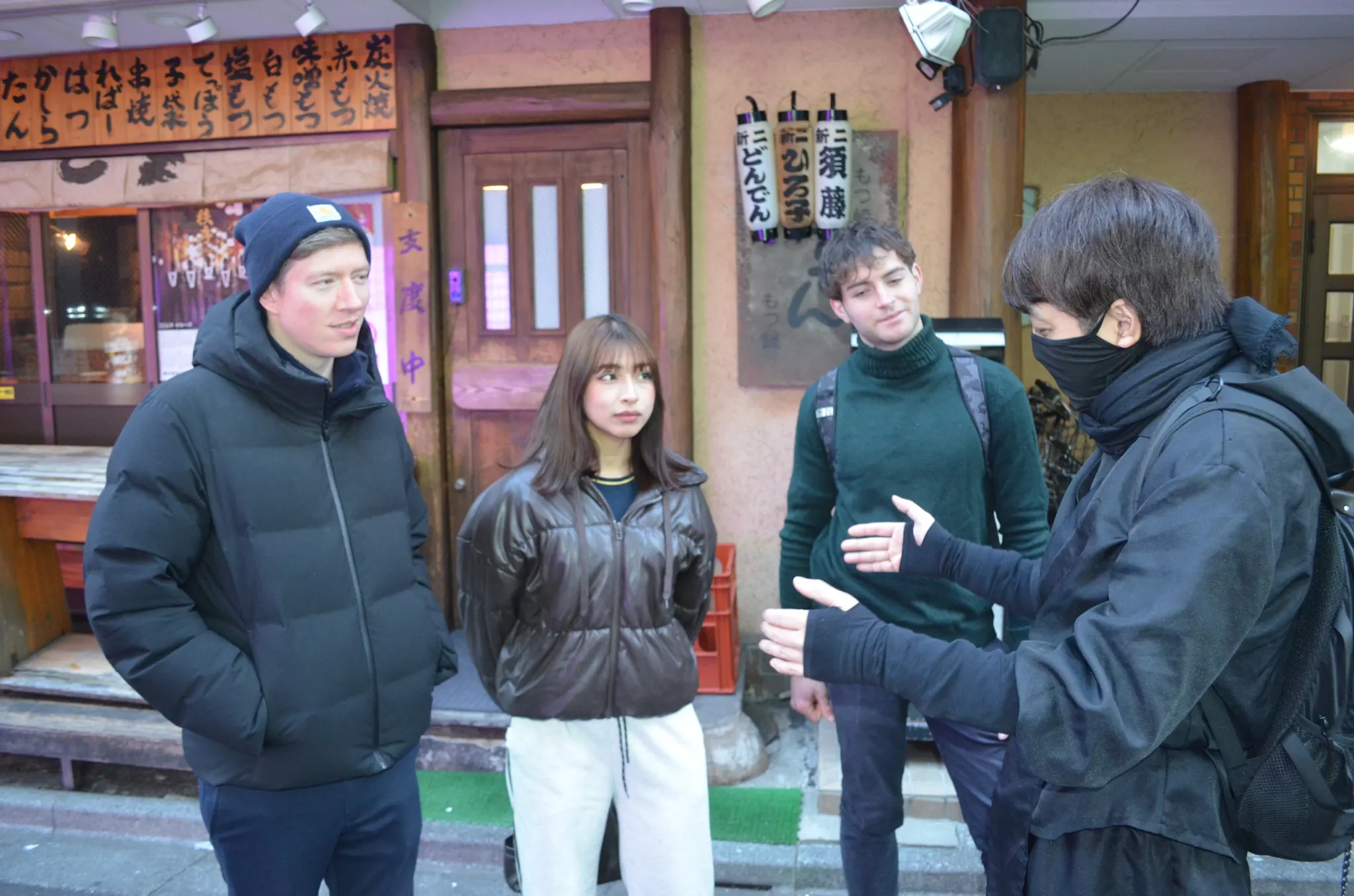 The local guide chatting with guests outside an izakaya in Nichome