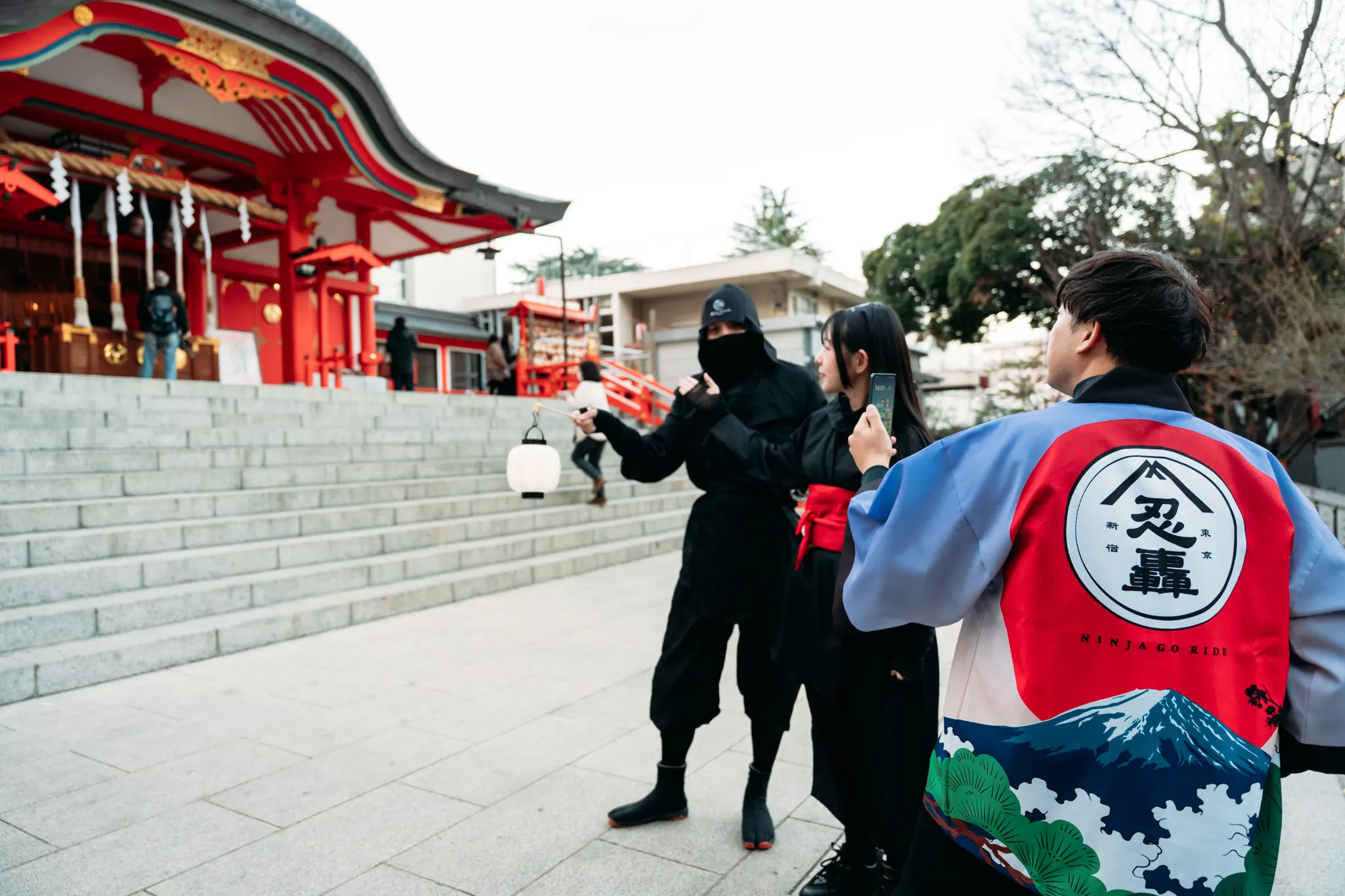 Guests with the Ninja guide on the steps of Hanazono Shrine